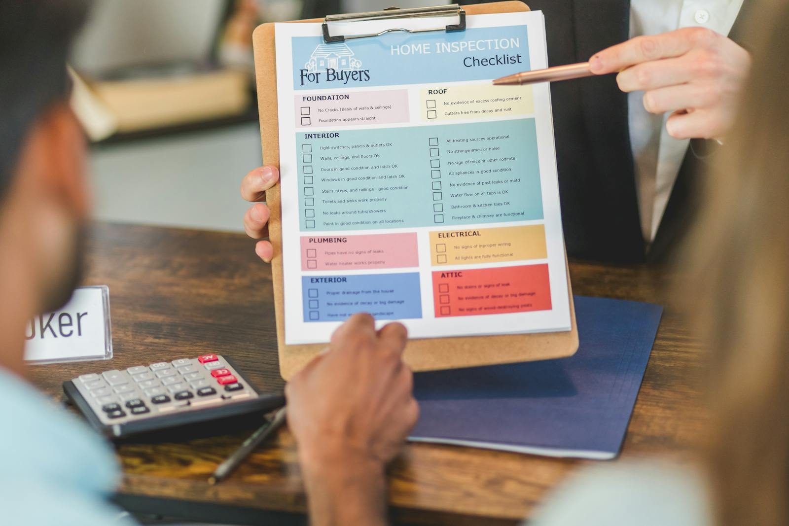 A service provider reviewing a checklist with clients at a desk