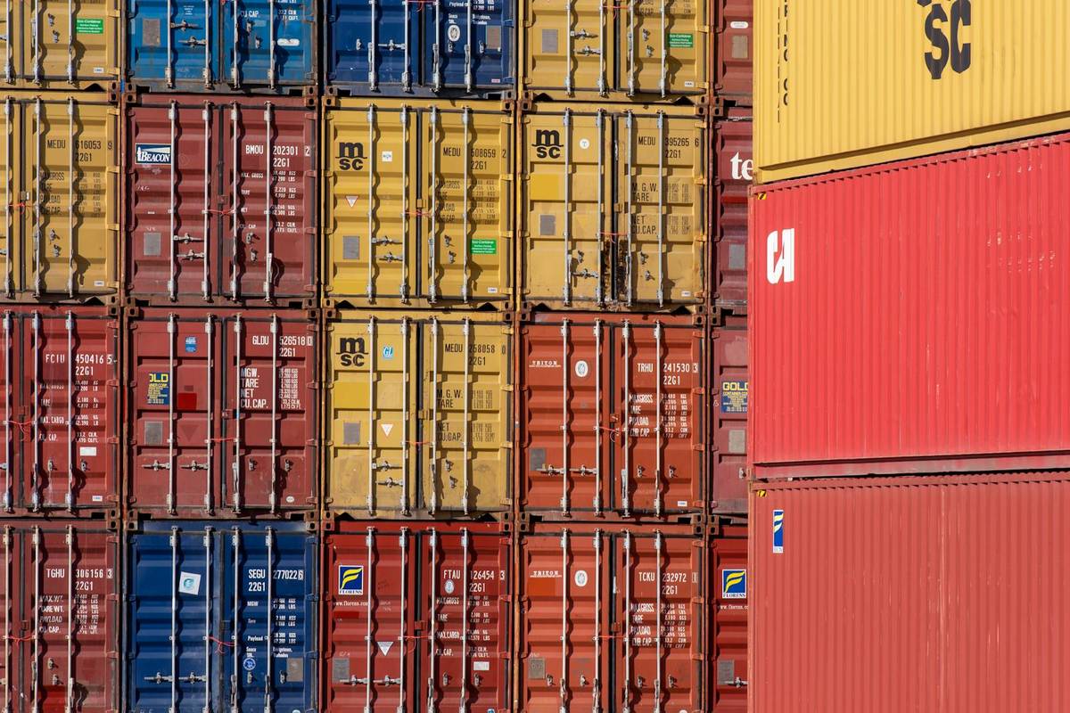Colorful shipping containers stacked in a port for cargo logistics
